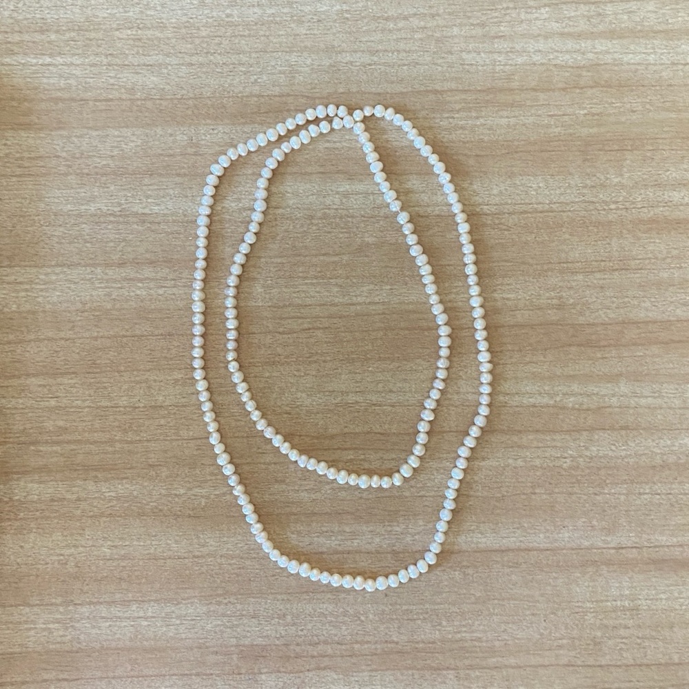 White pearl necklace 22.5” strand.